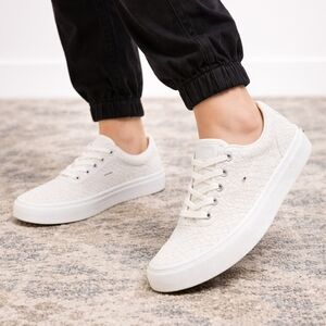 Vans low-top sneakers in a clean white snakeskin-textured finish. Size 6.5